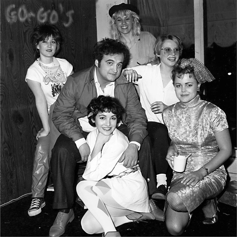 The Go-Go's backstage in 1980 with John Belushi. (Photo by Janette Beckman / Courtesy of UT Press)